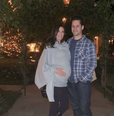 Leslie Lopez with her husband showing the baby bump on the occasion of New Years.